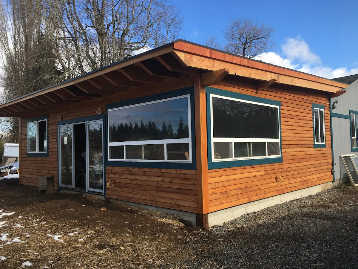 Single-story cedar-clad ADU with large picture windows